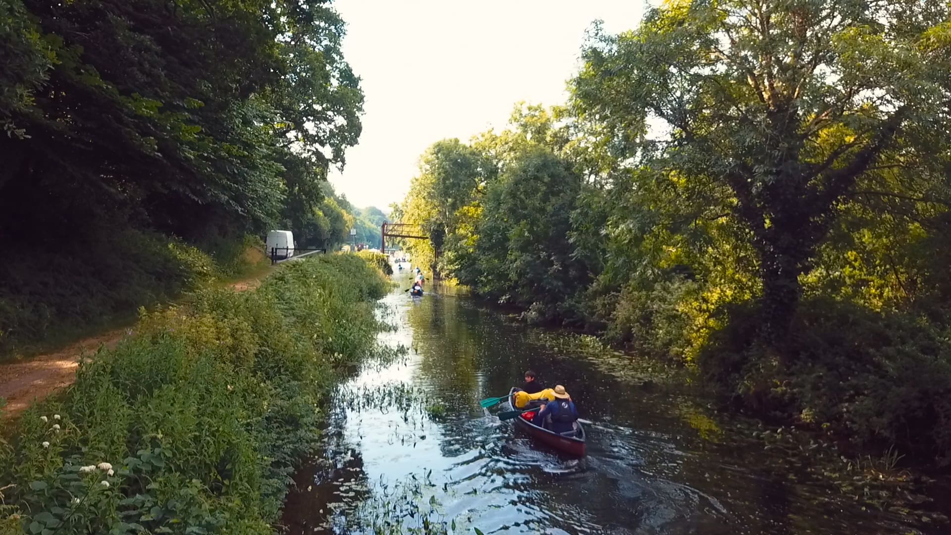 People canoeing in Ireland on a sunny day.